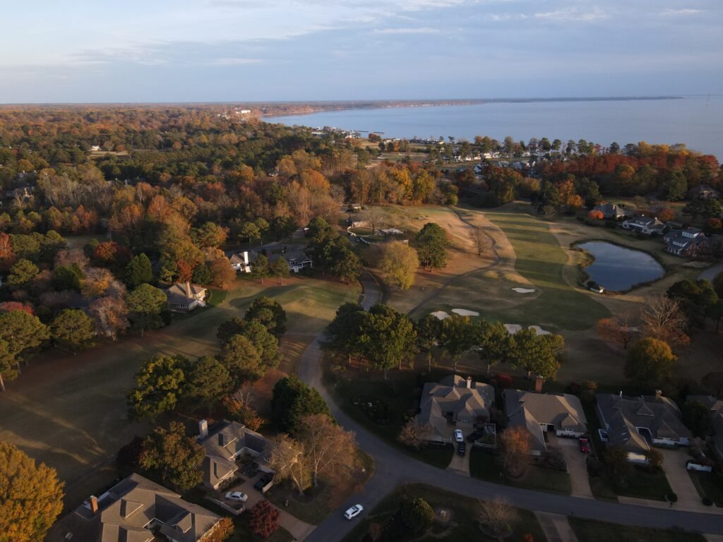default Kingsmill in Williamsburg, VA in the Fall including large homes, a golf course, and riverfront property